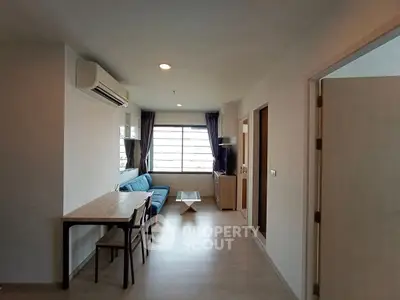 Modern living room with natural light and stylish furniture in a cozy apartment.