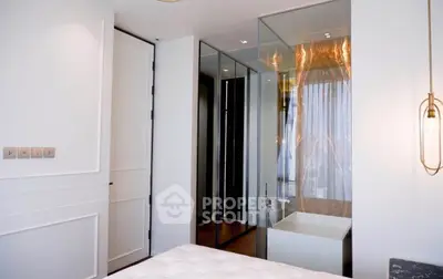 Modern bedroom with glass-walled ensuite bathroom and elegant lighting