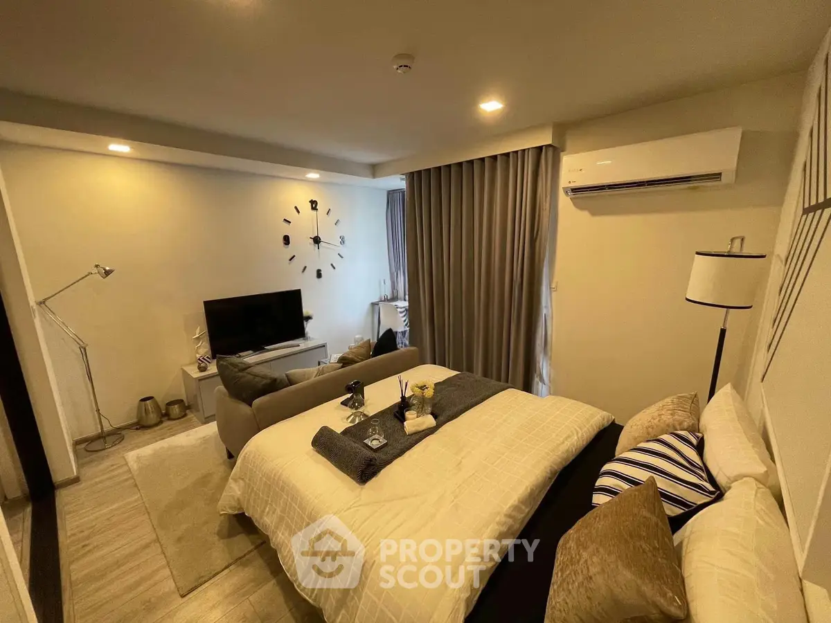 Modern studio apartment with cozy living area and stylish decor