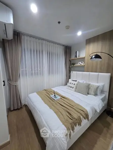 Cozy bedroom with modern decor and soft lighting, featuring a stylish bed and elegant curtains.