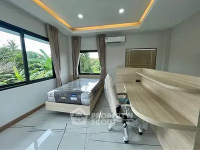 Modern bedroom with large windows and sleek furniture, offering a serene garden view.