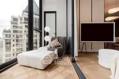 Modern living room with floor-to-ceiling windows and stylish decor in urban apartment.