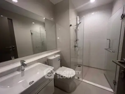 Modern bathroom with sleek fixtures and glass shower enclosure