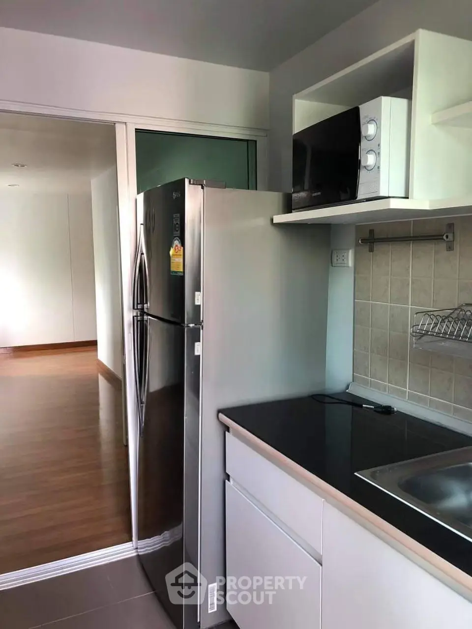 Modern kitchen with sleek appliances and open layout in a stylish apartment.
