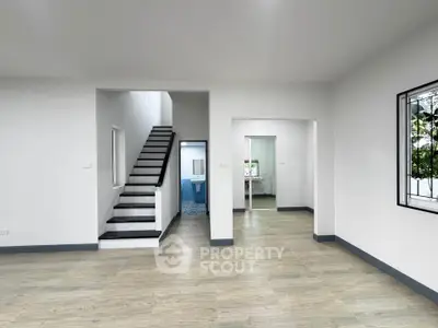 Spacious modern interior with staircase and open layout, perfect for family living.