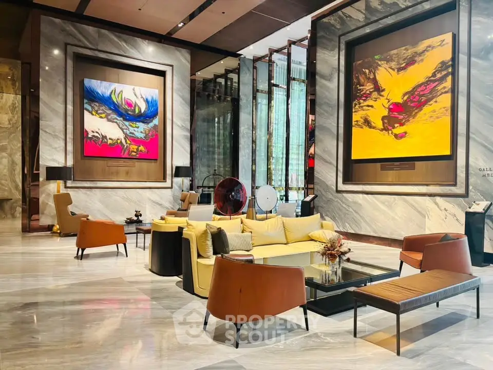 Luxurious modern lobby with elegant seating and vibrant artwork, perfect for upscale living.