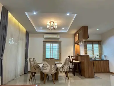 Elegant dining area with modern chandelier and open kitchen layout