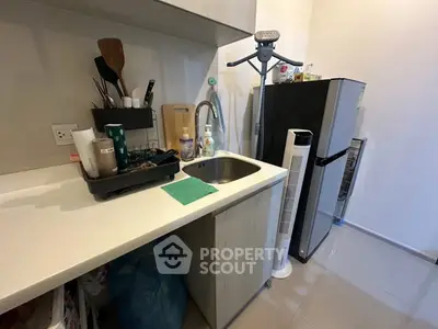 Compact kitchen with modern appliances and sleek countertop