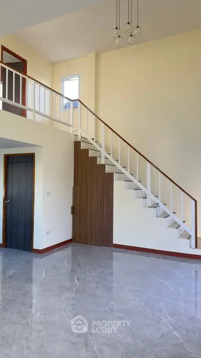 Spacious modern interior with elegant staircase and glossy marble flooring