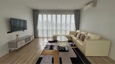 Spacious modern living room with large windows and elegant decor