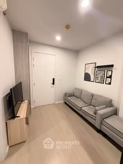 Modern living room with stylish decor and cozy gray sofa