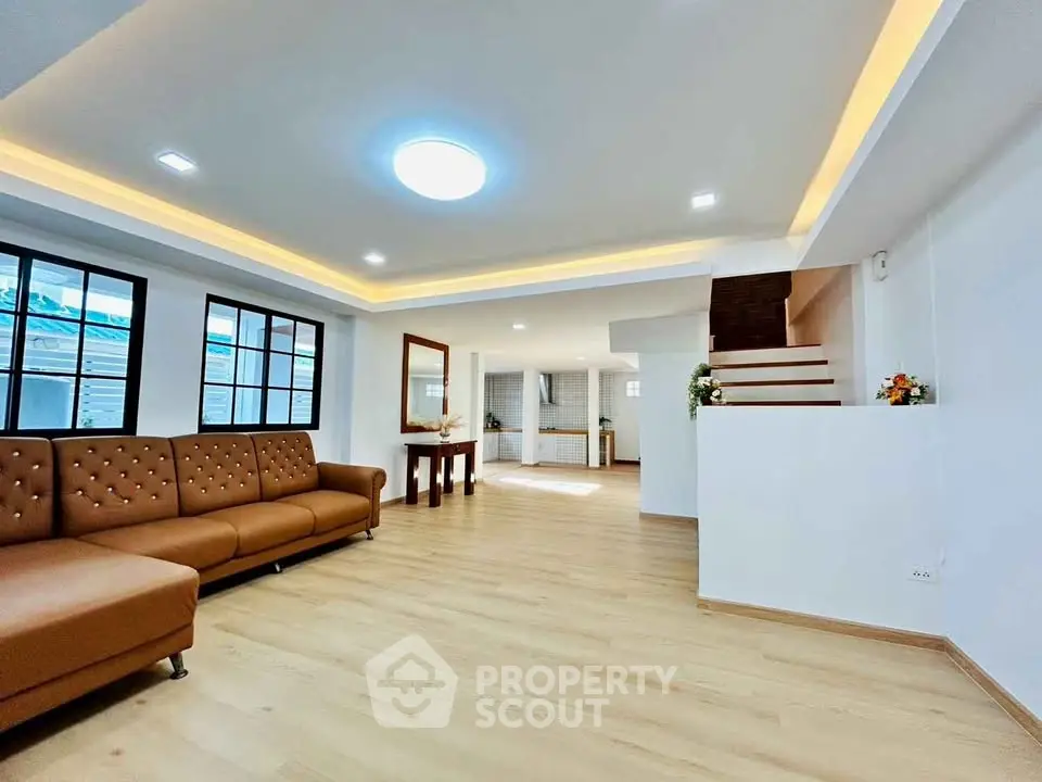 Spacious modern living room with elegant lighting and wooden flooring