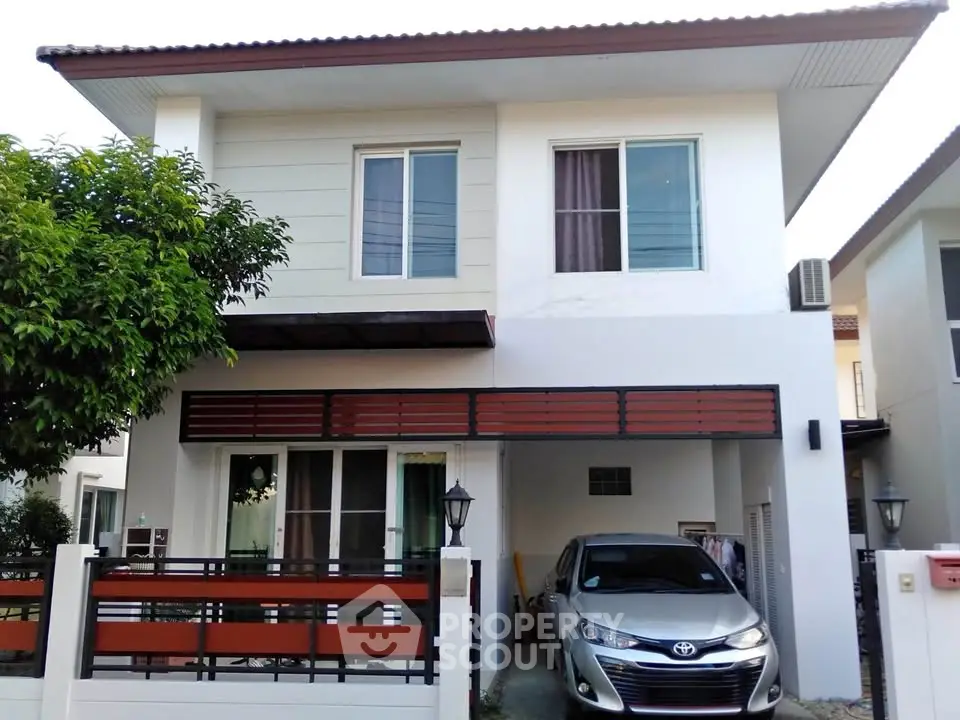 Modern two-story house with carport and sleek design in suburban neighborhood.