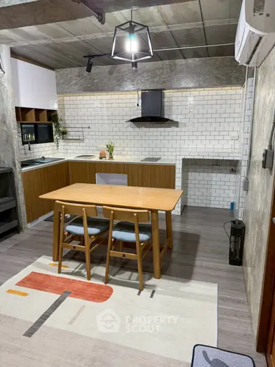 Modern kitchen with wooden cabinets and stylish dining area