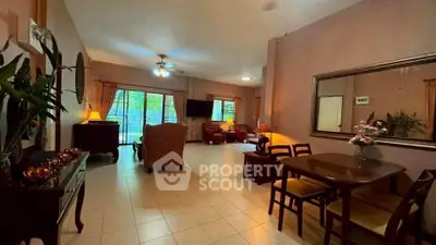Spacious living room with elegant decor and garden view, perfect for family gatherings.