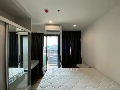 Modern bedroom with large window and city view, featuring a comfortable bed and sleek design.