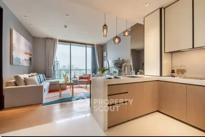 Modern open-plan living room and kitchen with city view, stylish decor, and ample natural light.