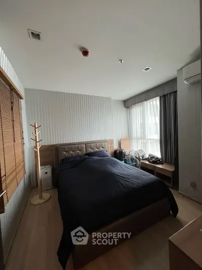 Cozy bedroom with modern decor and ample natural light