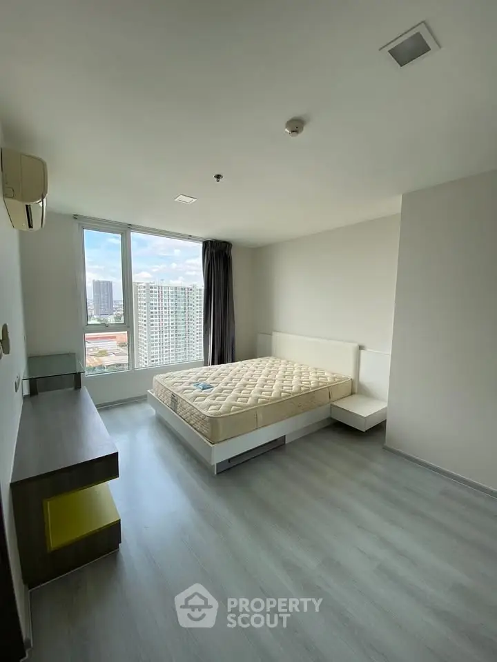 Spacious bedroom with city view in modern apartment