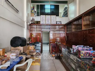 Spacious storage room with wooden cabinets and glass display cases