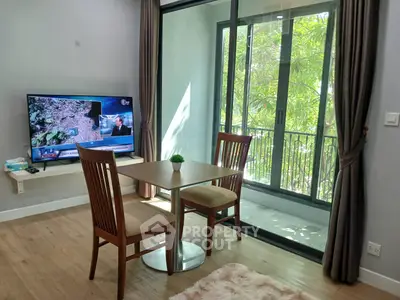 Cozy living room with dining set and balcony view in modern apartment