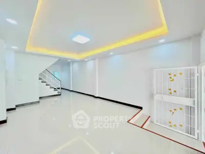 Spacious modern living room with sleek lighting and glossy tile flooring