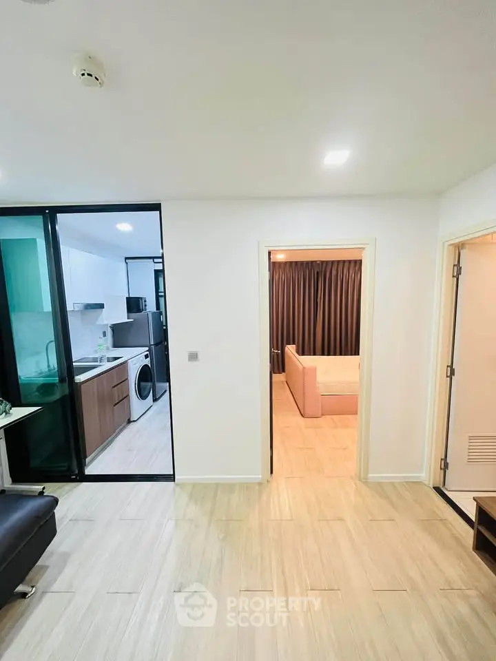 Modern apartment interior with open kitchen and cozy living room