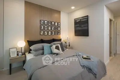 Modern bedroom with stylish decor and cozy bedding in a contemporary apartment.