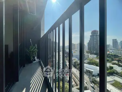 Stunning city view from a modern high-rise balcony with sleek railing design.
