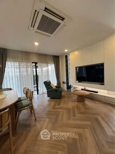 Spacious living room with modern decor and large windows for natural light