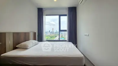 Modern bedroom with city view, featuring a large window and minimalist decor.