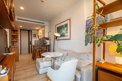 Cozy living room with modern decor and open kitchen layout in a stylish apartment.