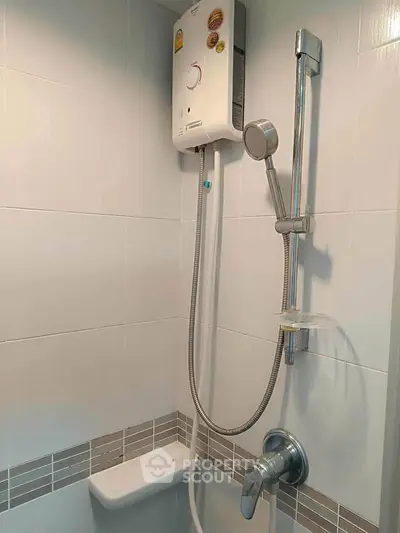 Modern bathroom with sleek shower and water heater in stylish apartment.