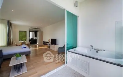 Spacious open-plan living room with modern bathtub and stylish decor