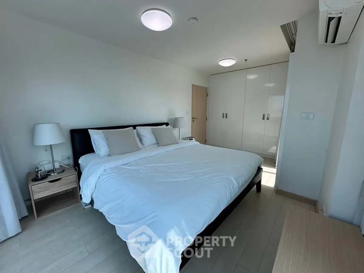 Spacious modern bedroom with large bed and ample natural light