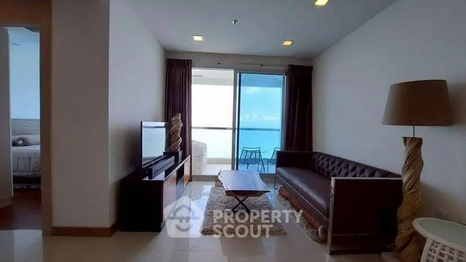 Spacious living room with ocean view balcony in modern apartment