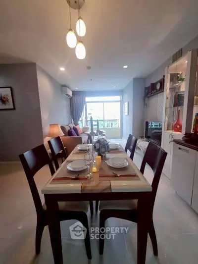 Elegant dining area with modern decor and natural light in a stylish apartment.