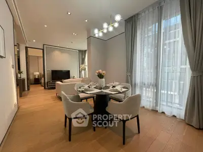 Elegant open-plan living and dining area with modern decor and large windows