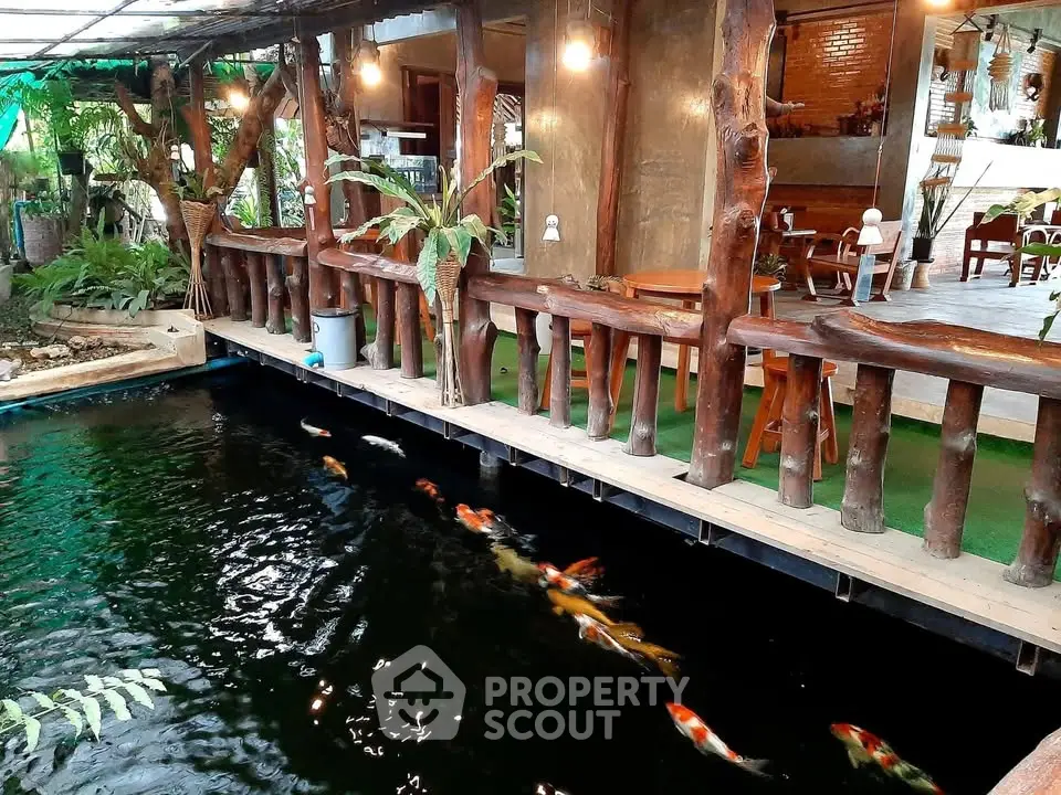 Charming koi pond with rustic wooden deck in serene garden setting