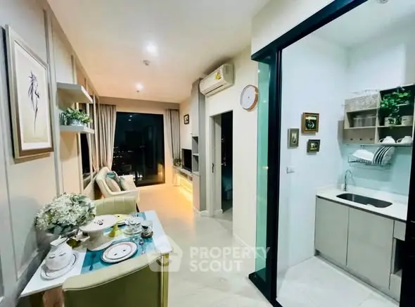 Modern open-layout living room with elegant decor and compact kitchen area, featuring a cozy dining setup.