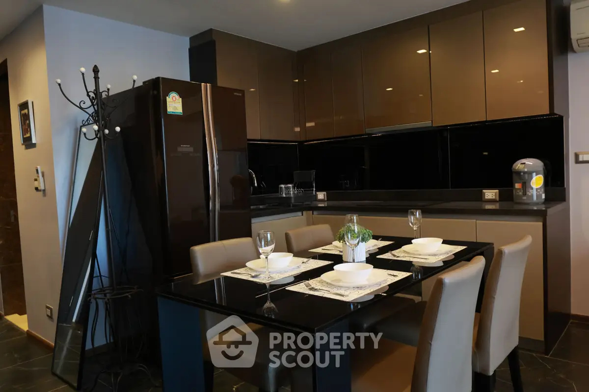 Modern kitchen with sleek cabinets and dining area in stylish apartment