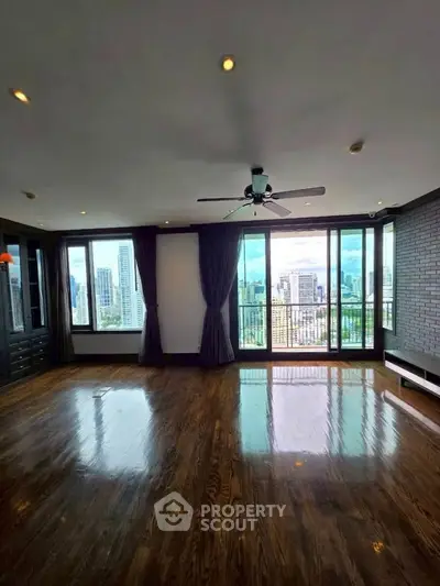 Spacious living room with stunning city view and hardwood floors