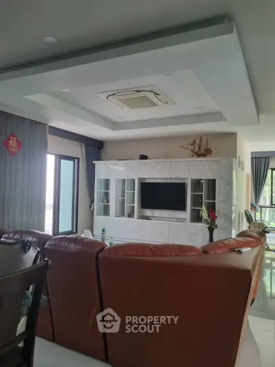 Spacious living room with modern decor and large leather sofa