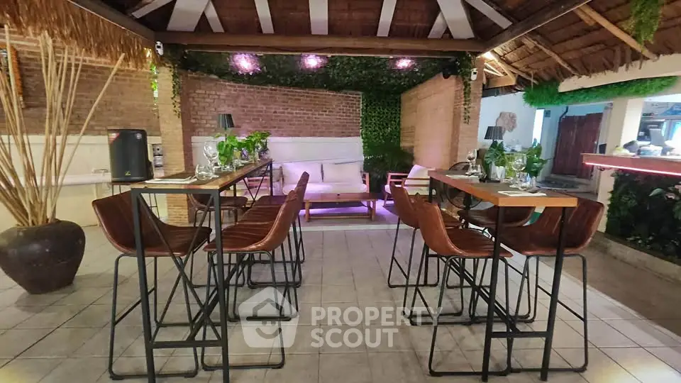 Charming outdoor patio with stylish seating and ambient lighting, perfect for entertaining or relaxing.