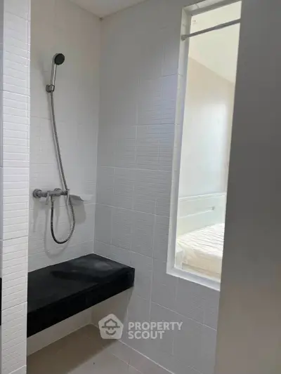 Modern bathroom with sleek shower and window for natural light