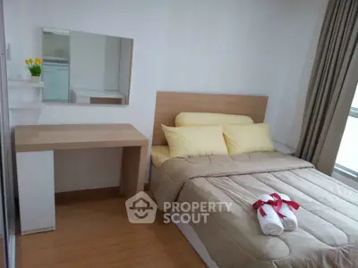 Cozy bedroom with modern decor and natural light, featuring a comfortable bed and stylish desk.