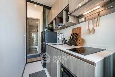 Modern kitchen with sleek cabinetry and built-in appliances, featuring a compact yet efficient design.