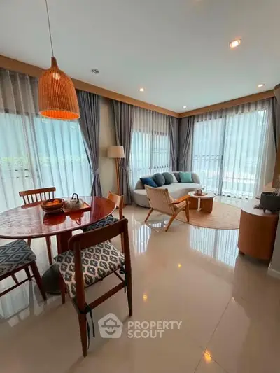 Spacious living room with modern decor and large windows offering natural light.