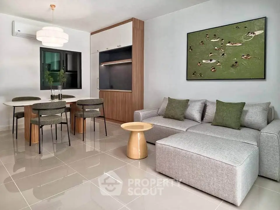 Modern living room with stylish furniture and elegant dining area