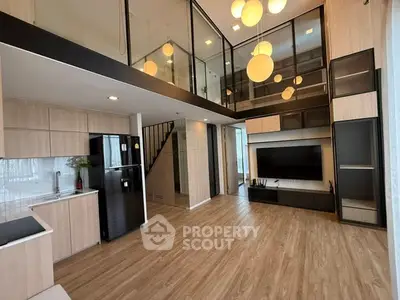 Modern loft-style living room with high ceilings and elegant lighting